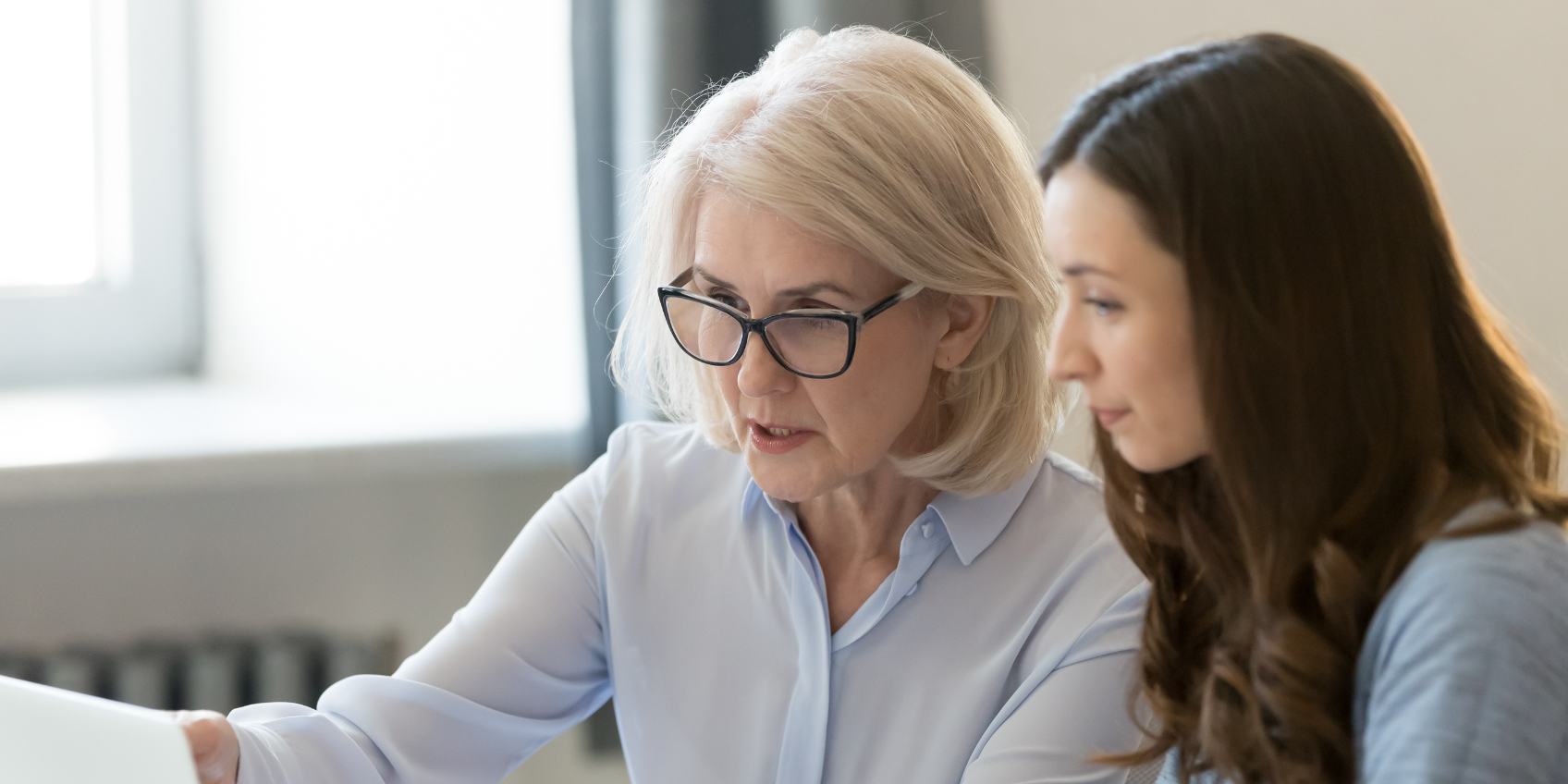 Manager coaching employee with regular performance review discussions